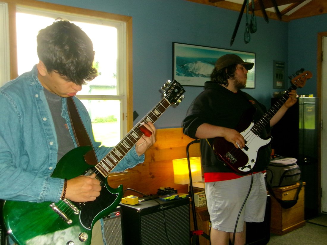 Jed and Zane playing guitar and bass at practice